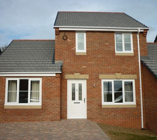 Brick new build with white windows and door