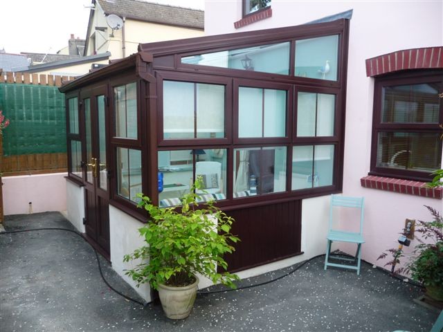 Rosewood conservatory with a customer's plants