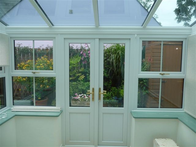 Finished conservatory interior with French doors