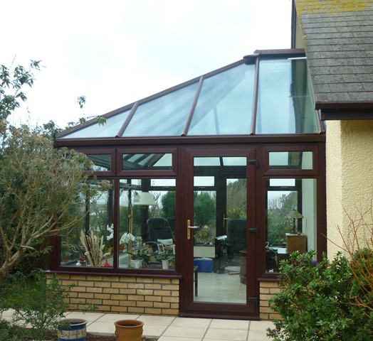 Woodgrain conservatory with glass roof