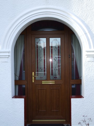 Arched rosewood front door